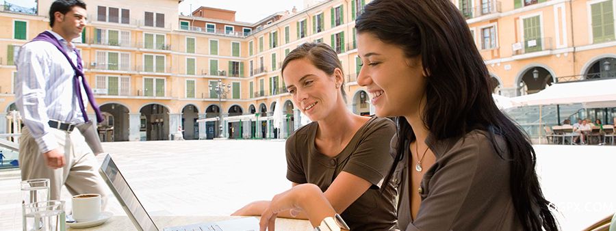 Businesswomen looking at laptop outside cafe.jpg